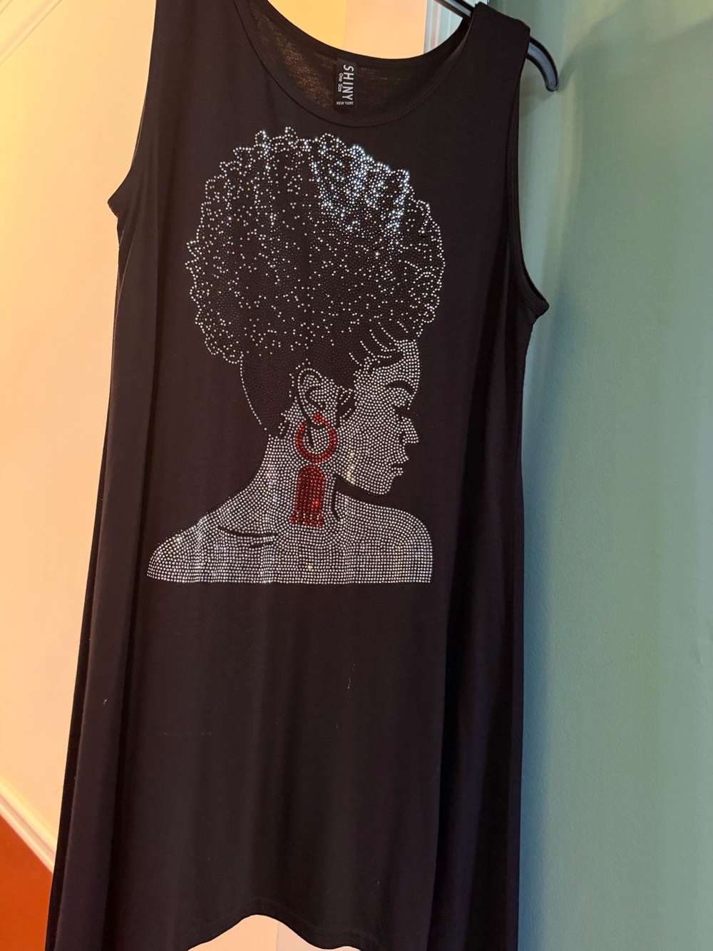 Sophisticated sleek, shiny black sleeveless top featuring dazzling rhinestones